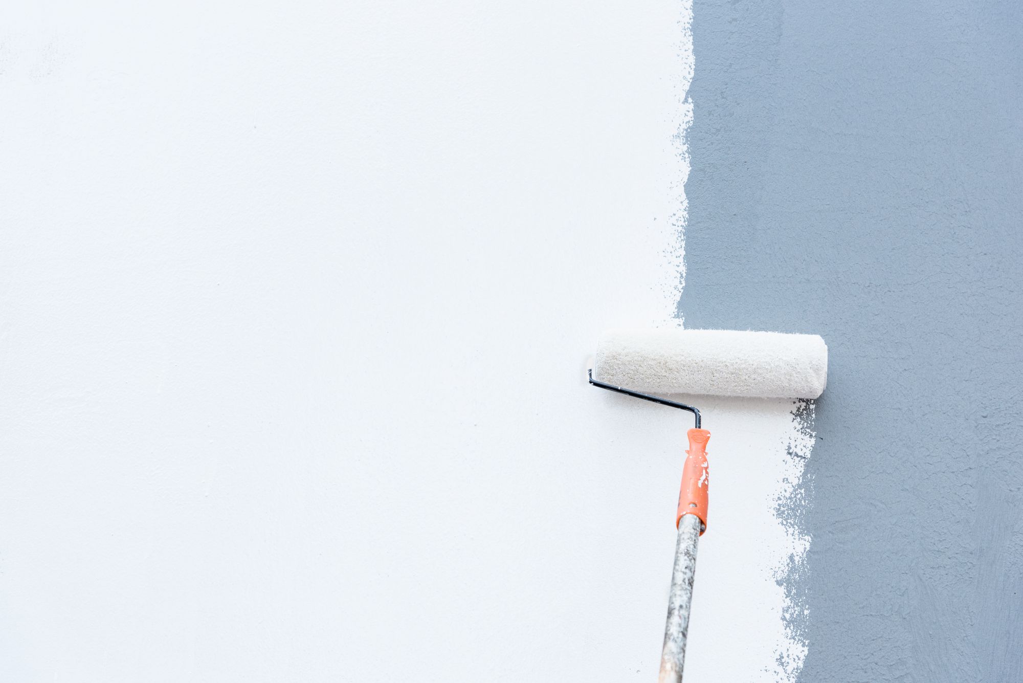 A paint roller on an exterior wall